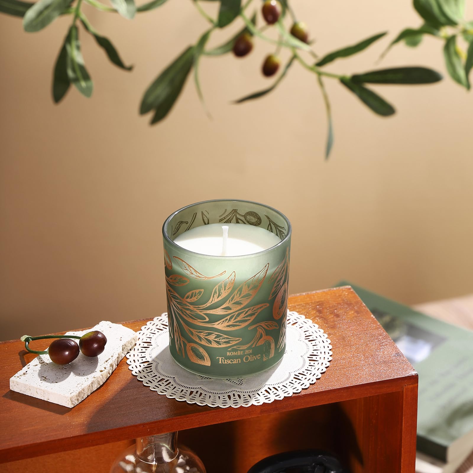 ROMIIE ZOI 6oz candle rests on a coffee table for cozy evenings.