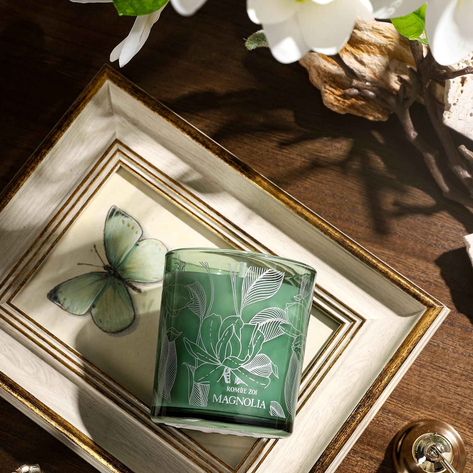 ROMIIE ZOI magnolia candle on a dining table evokes cozy evenings