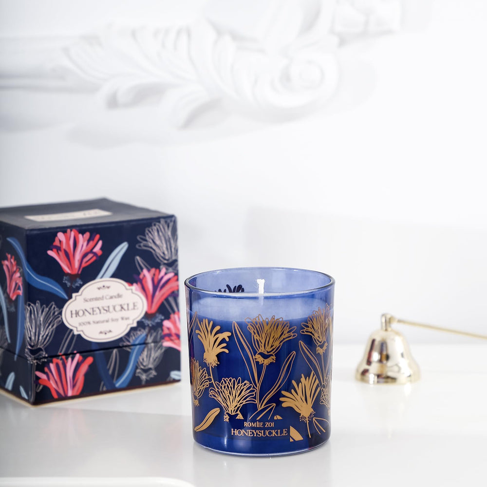 ROMIIE ZOI 6oz soy wax candle burning for a clean, long-lasting scent.