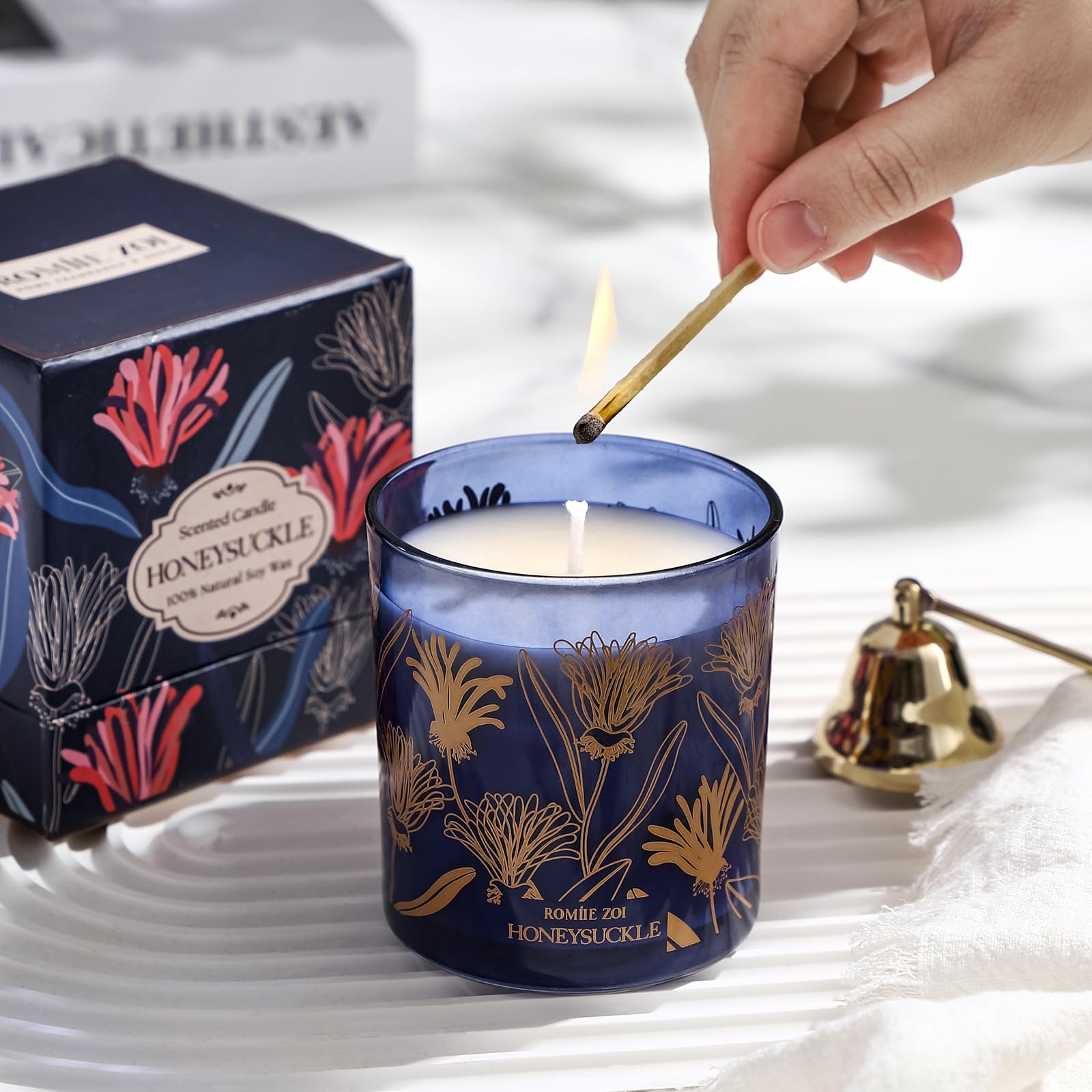 ROMIIE ZOI compact candle on a desk, boosting calm office ambiance.