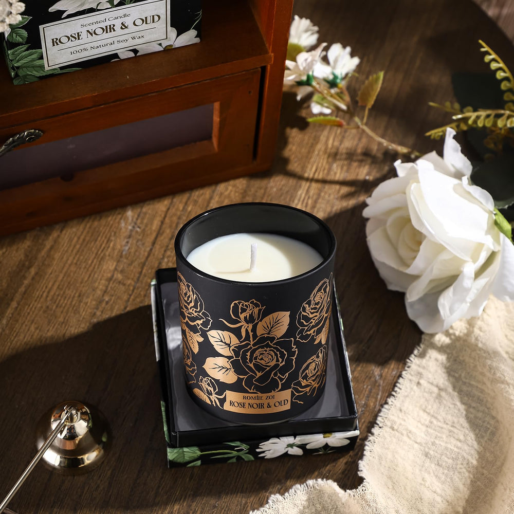 ROMIIE ZOI Rose Noir & Oud candle in a warm living space; soothing scent.
