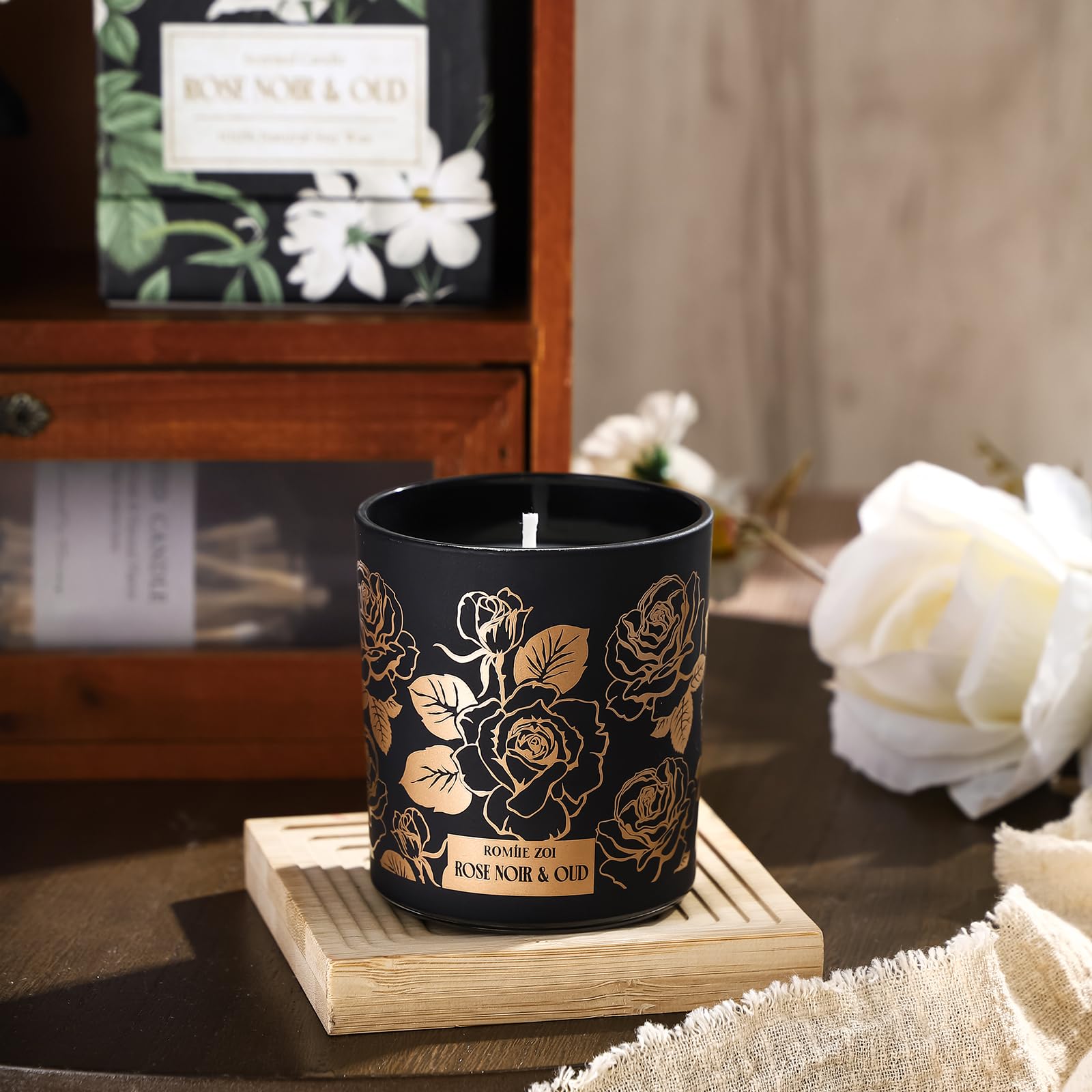 ROMIIE ZOI Rose Noir & Oud candle with lid off; cozy room decor and aroma.