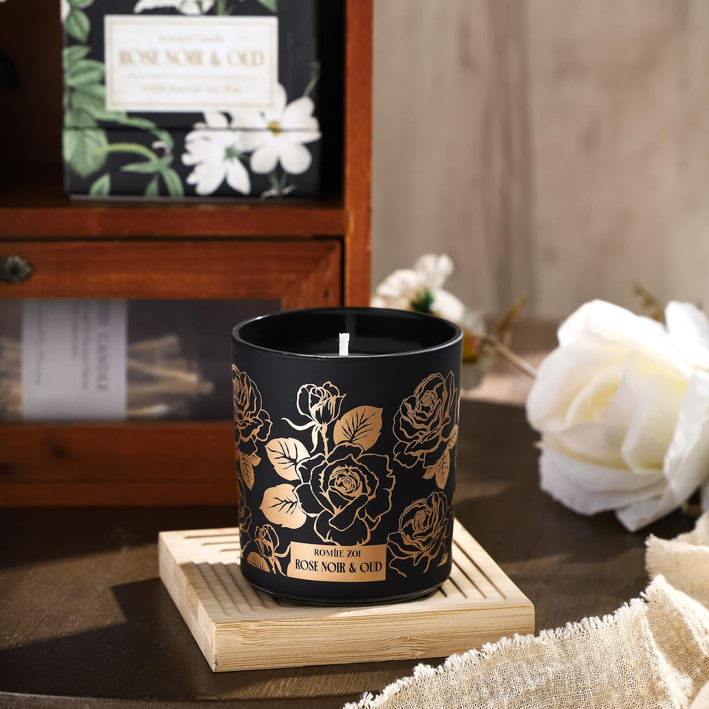 ROMIIE ZOI Rose Noir & Oud candle with lid off; cozy room decor and aroma.
