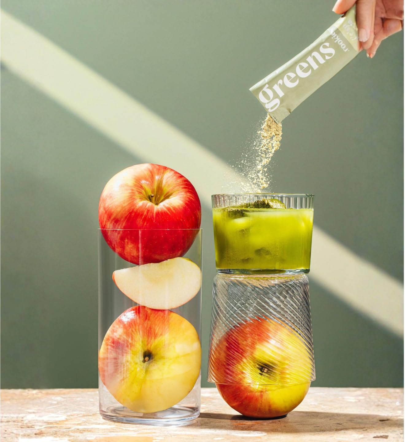 Rookie Wellness Greens mixed with water in a glass for a crisp drink