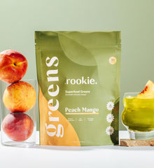 Scoop of Rookie Wellness Greens ready to mix for an easy, on-the-go wellness boost.