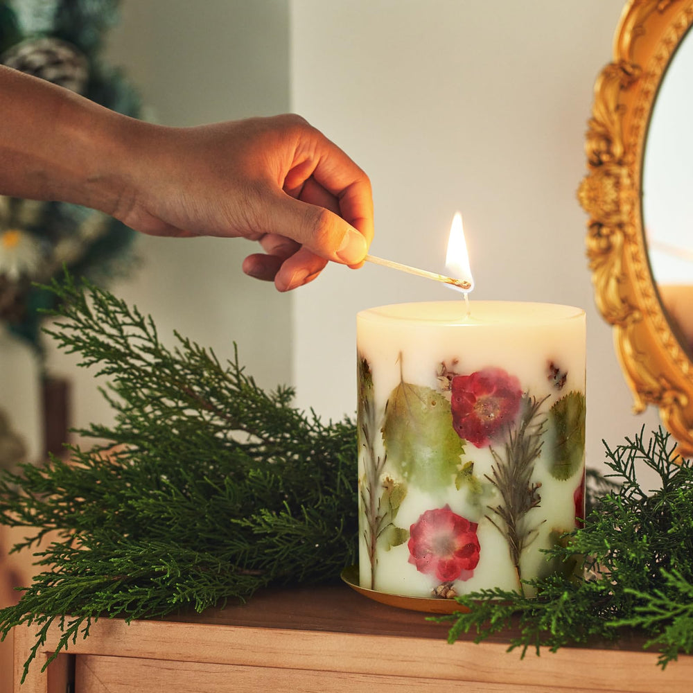 Rosy Rings Essence of Christmas candle includes alpine vetiver for earthy warmth.