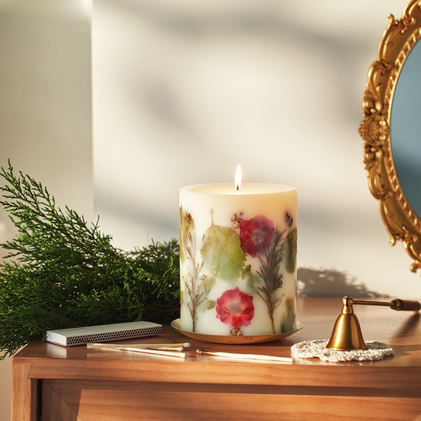 Rosy Rings Essence of Christmas candle showcases hemlock cones for seasonal decor.