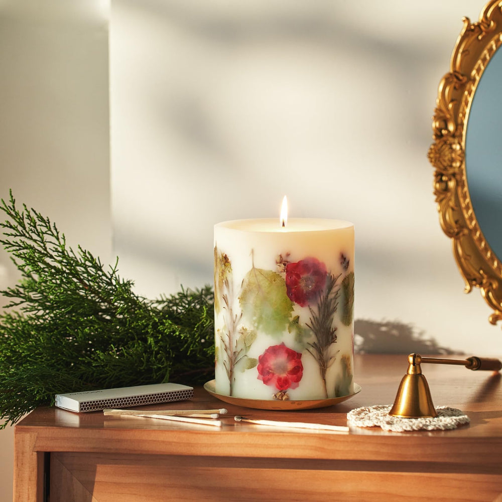 Rosy Rings Essence of Christmas candle showcases hemlock cones for seasonal decor.