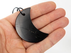 RUMINERAL Karelia shungite pendant half-moon worn daily for balance.