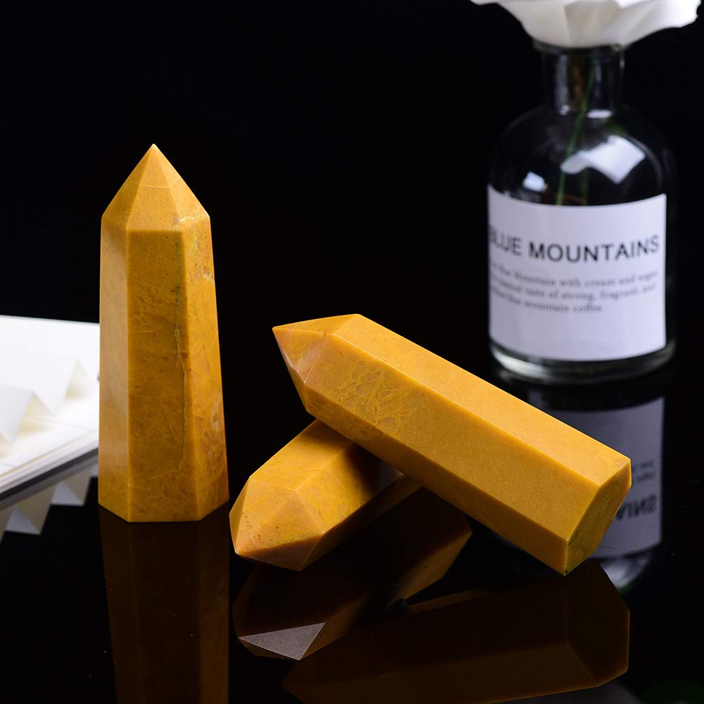 Desk or altar setup featuring a yellow aventurine wand with warm glow.