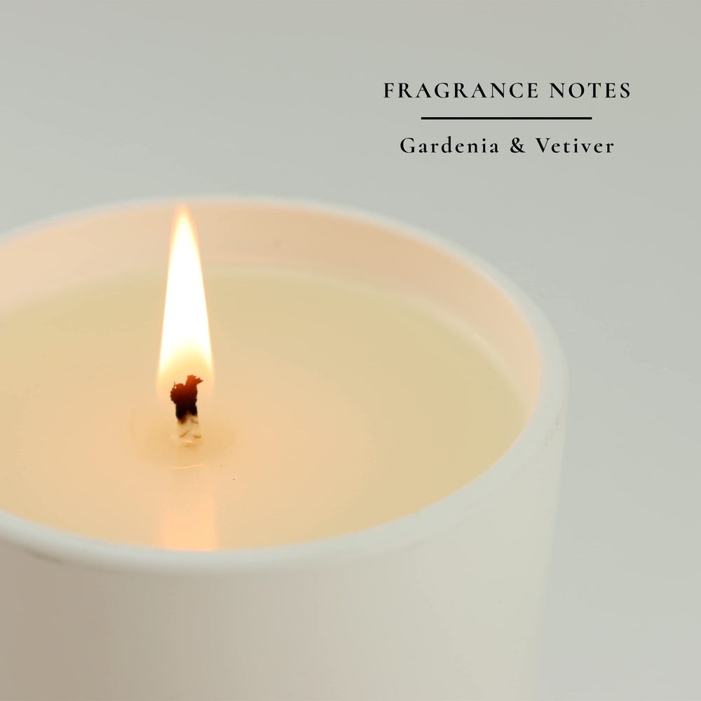 Sacred + Divine 444 gardenia and vetiver aromatherapy candle creating serene ambiance.