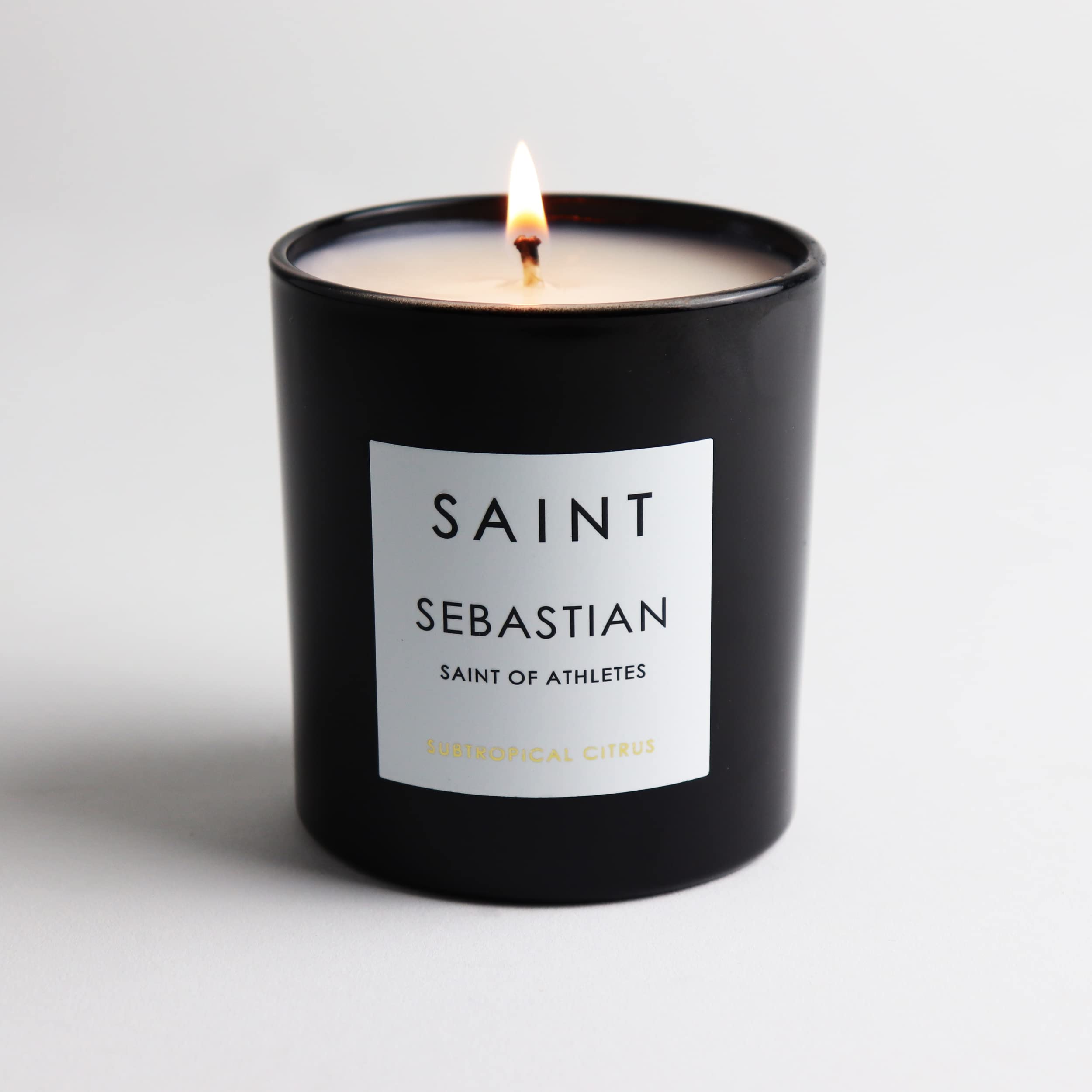 Close-up of Italian prayer coin embedded in the SAINT Sebastian candle for a meaningful keepsake.