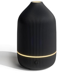 Salubrito compact essential oil diffuser in black on a desk, space-saving design
