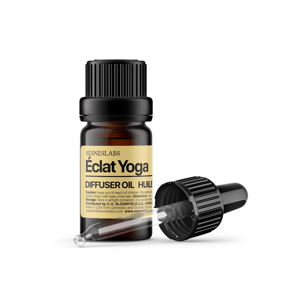 sesneslabs Éclat Yoga Diffuser Oil bottle glows with citrus energy for mindful practice.