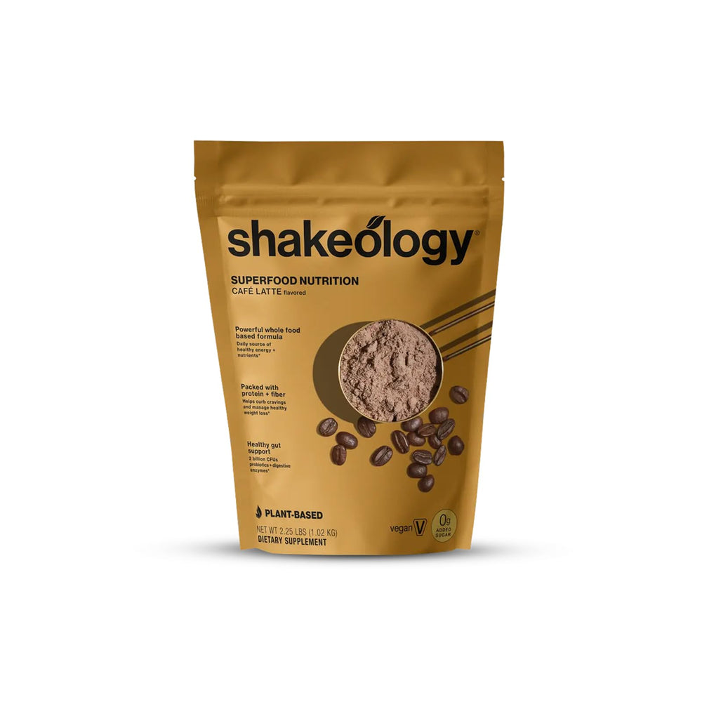 Shakeology Cafe Latte tub front shows plant-based protein and 0g added sugar.