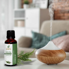 Sheer Essence Cypress Oil candle crafting with evergreen notes.