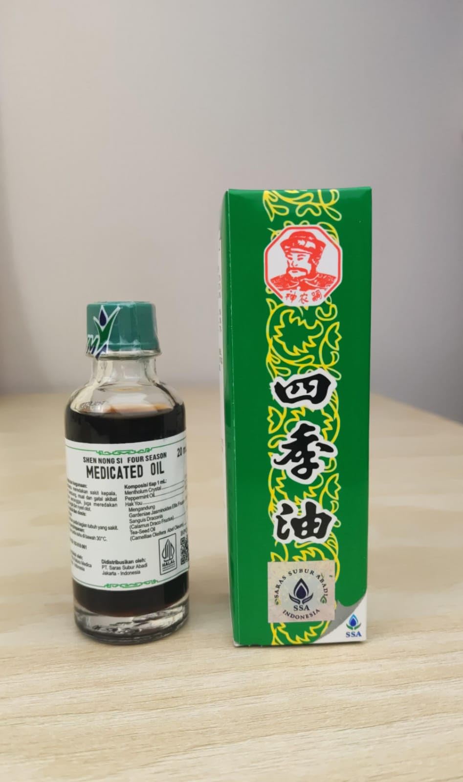 Shen Nong Si Four Season medicated oil bottle pour for targeted on-skin relief.