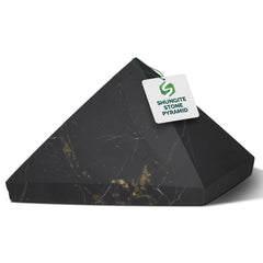 Shungite World authentic shungite pyramid 30mm sits on a desk for energy balance.