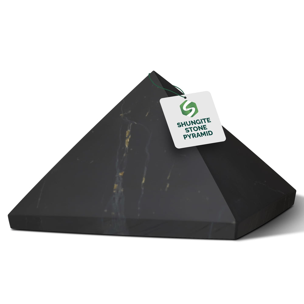 Shungite World Shungite Pyramid 40mm on desk for grounding and focus.
