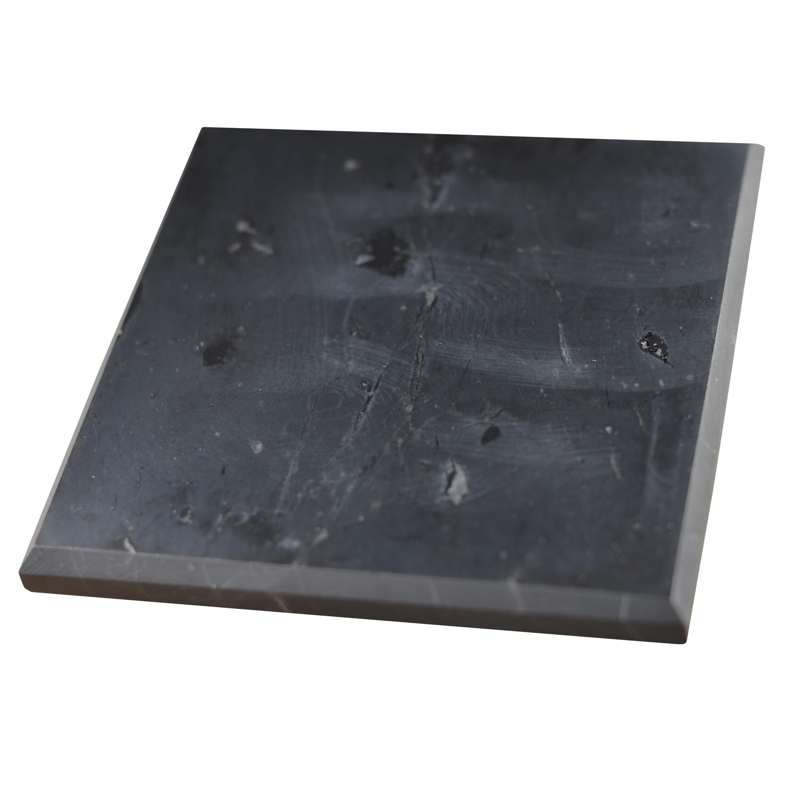 Shungite World polished 100x100mm tile shown as a balanced charging plate on a desk