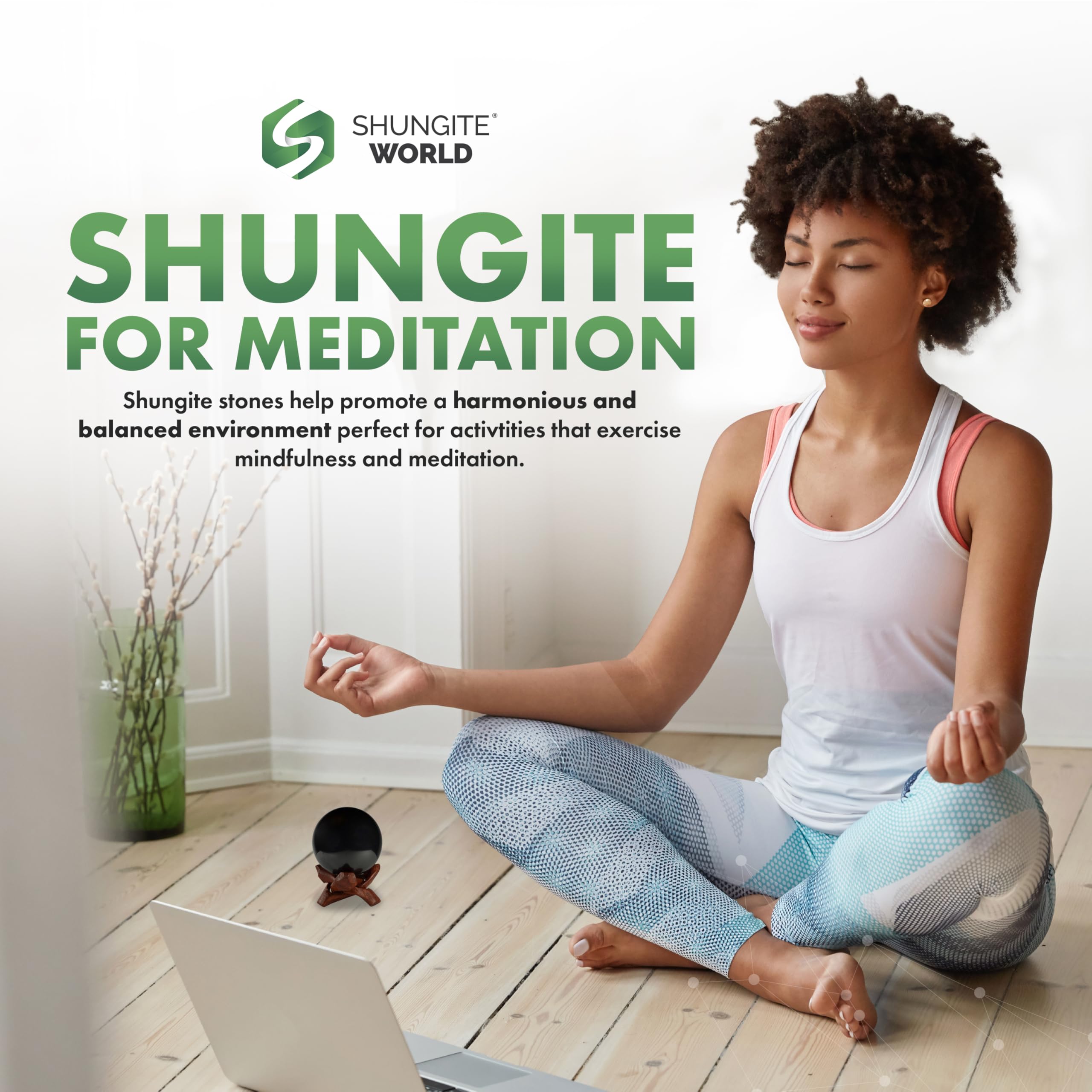 Shungite World sphere on workspace for energy balance around devices.
