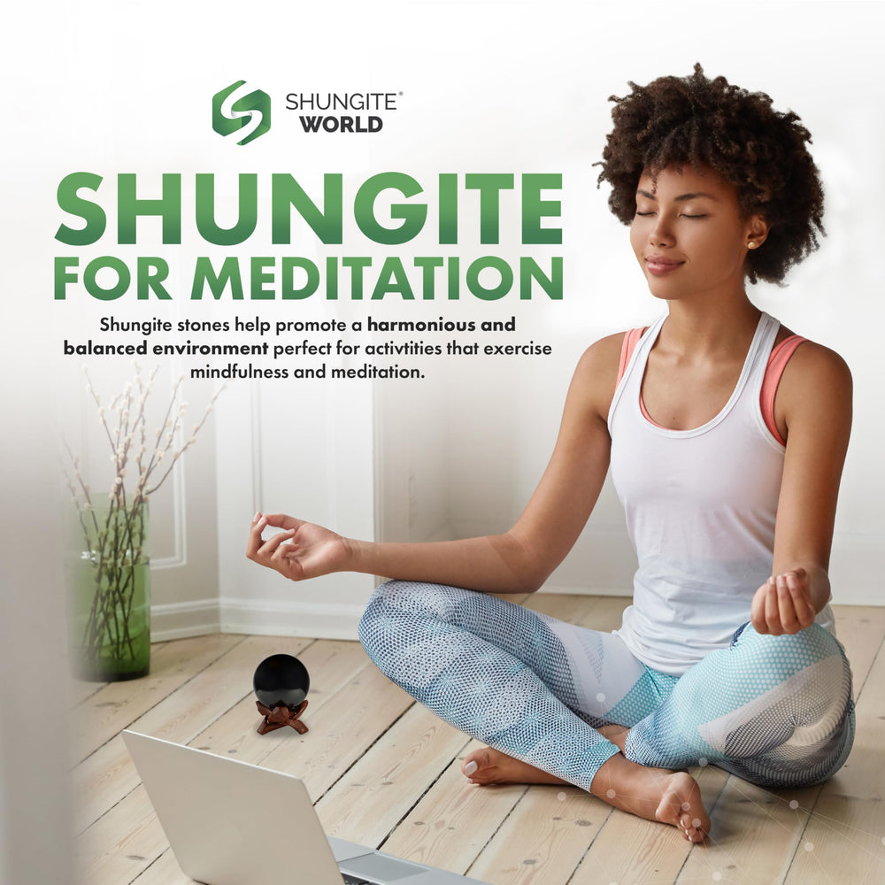 Shungite World sphere on workspace for energy balance around devices.