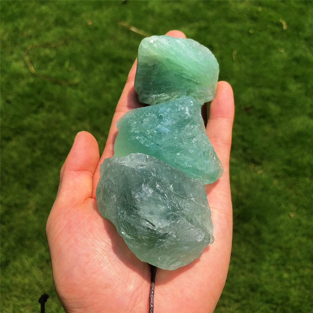 Simurg green fluorite rough 1lb in-hand view highlights size and rugged beauty.