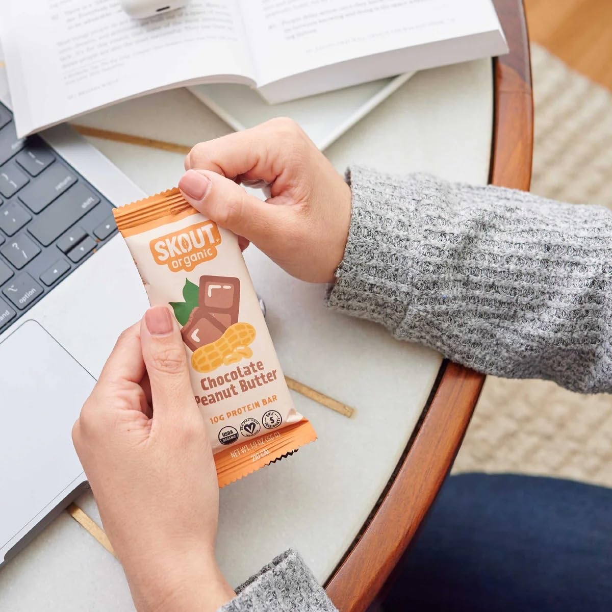 Snack-ready Skout bars beside a lunchbox and coffee