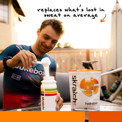 Skratch Labs Hydration Orange canister front with real fruit flavor cue