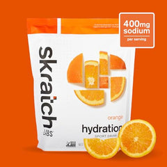 Skratch Labs Hydration Powder Orange dissolving in water to create a refreshing drink.