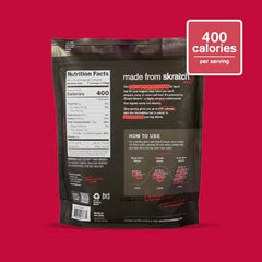 Pouring Skratch Labs hydration drink from bottle showcasing raspberry flavor