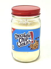 S&M Candle Factory chocolate chip cookies jar candle on shelf, rich bakery scent in a cozy room.