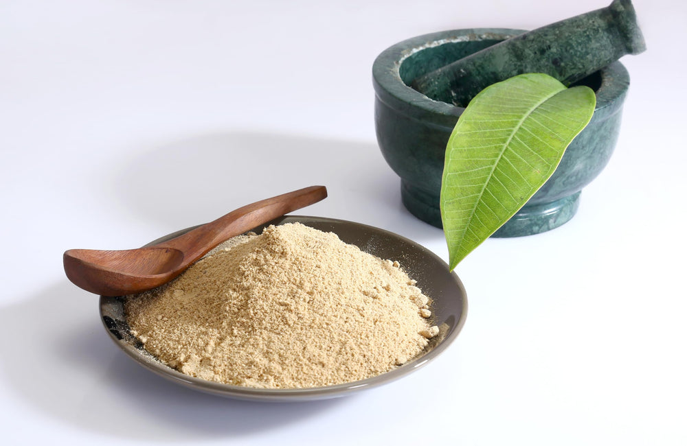 Solo Therapy Gokshura powder scoop beside a glass of juice