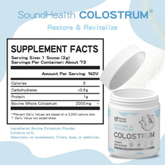 Scoop beside a glass of SoundHealth colostrum powder for easy mixing.