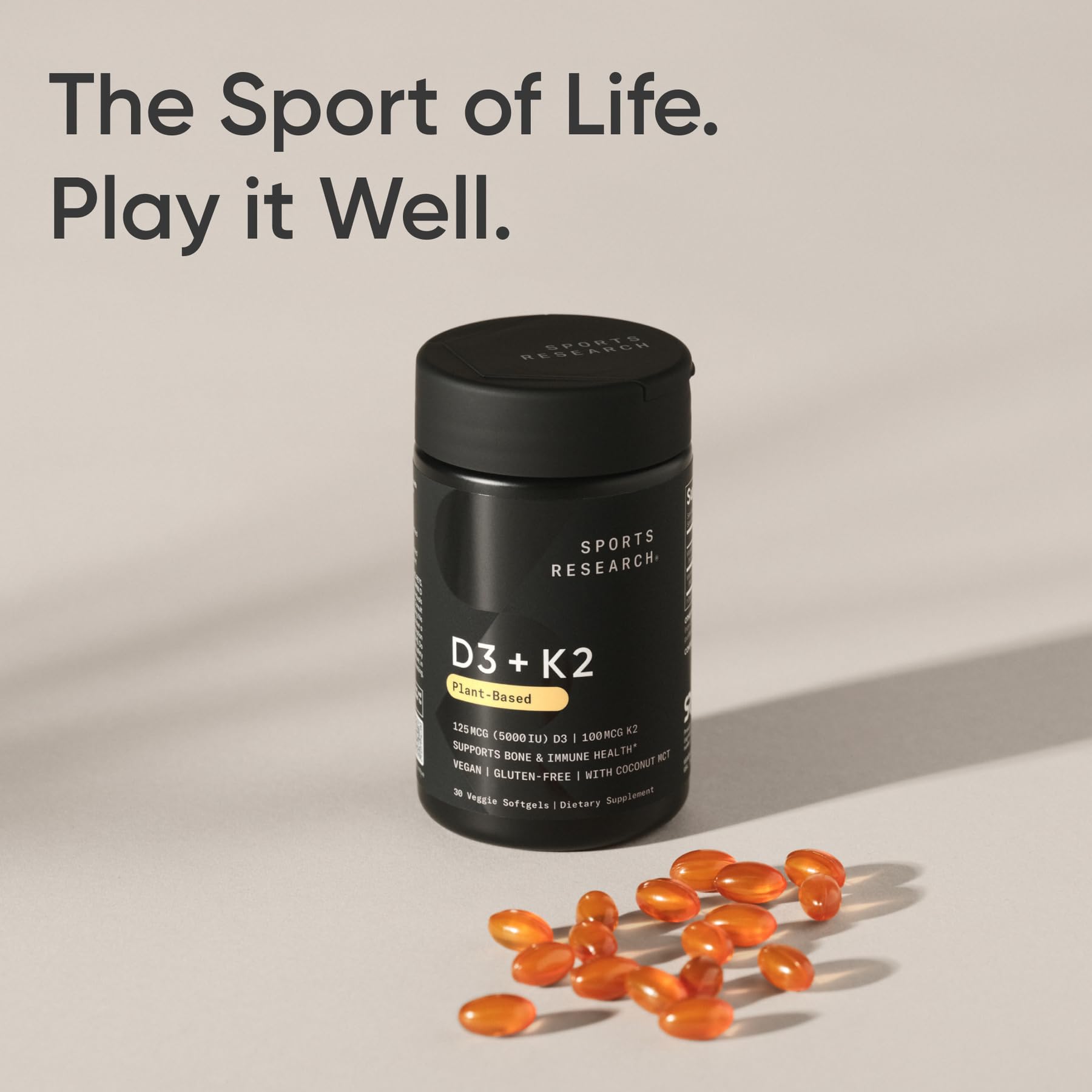 Sports Research vegan D3 K2 softgel beside water illustrates convenience.
