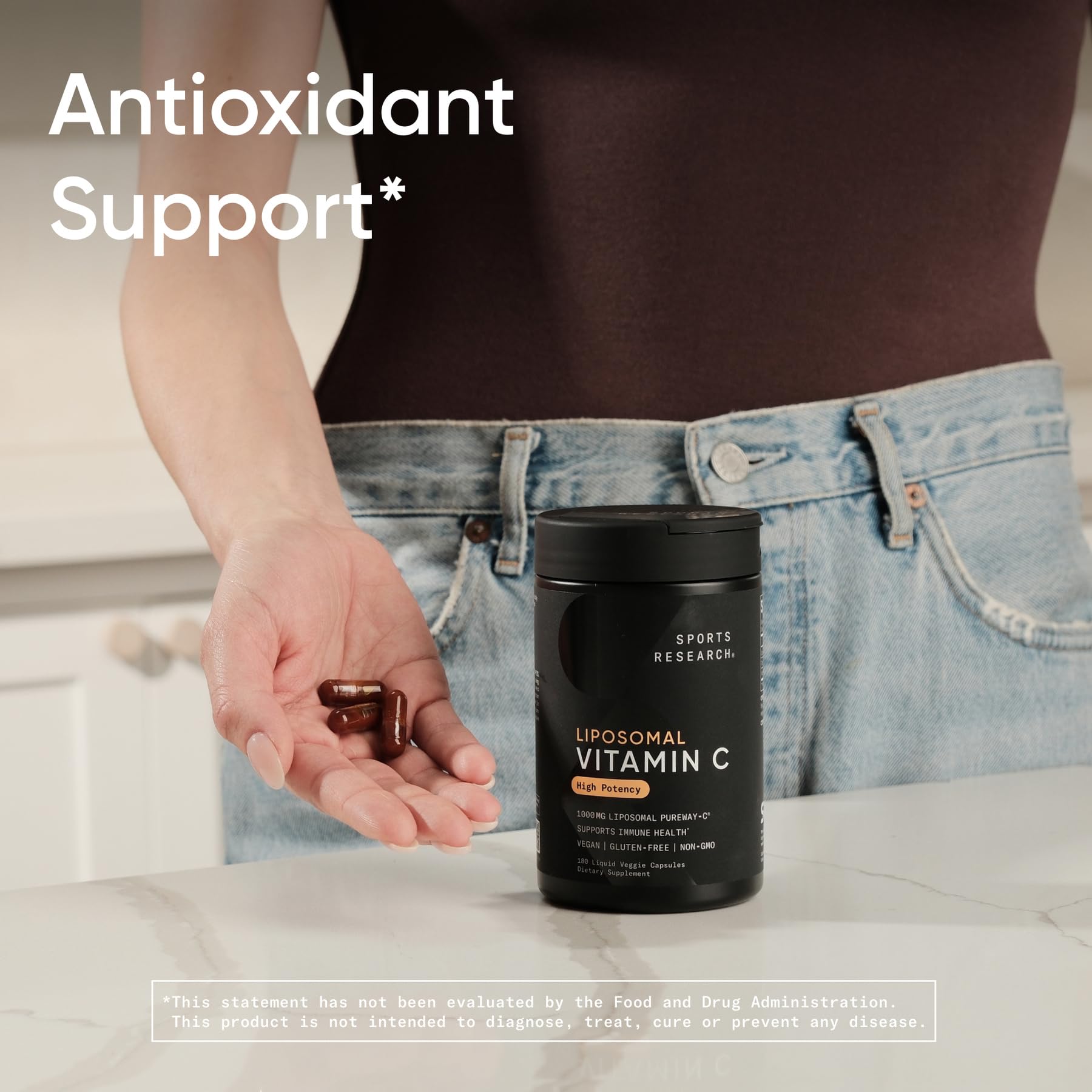 Sports Research vitamin C capsules in hand illustrating portable daily use.