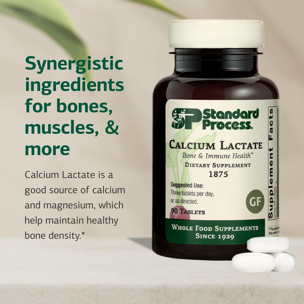 Close-up of Standard Process Calcium Lactate tablets showing non-dairy vegan formulation for bone health