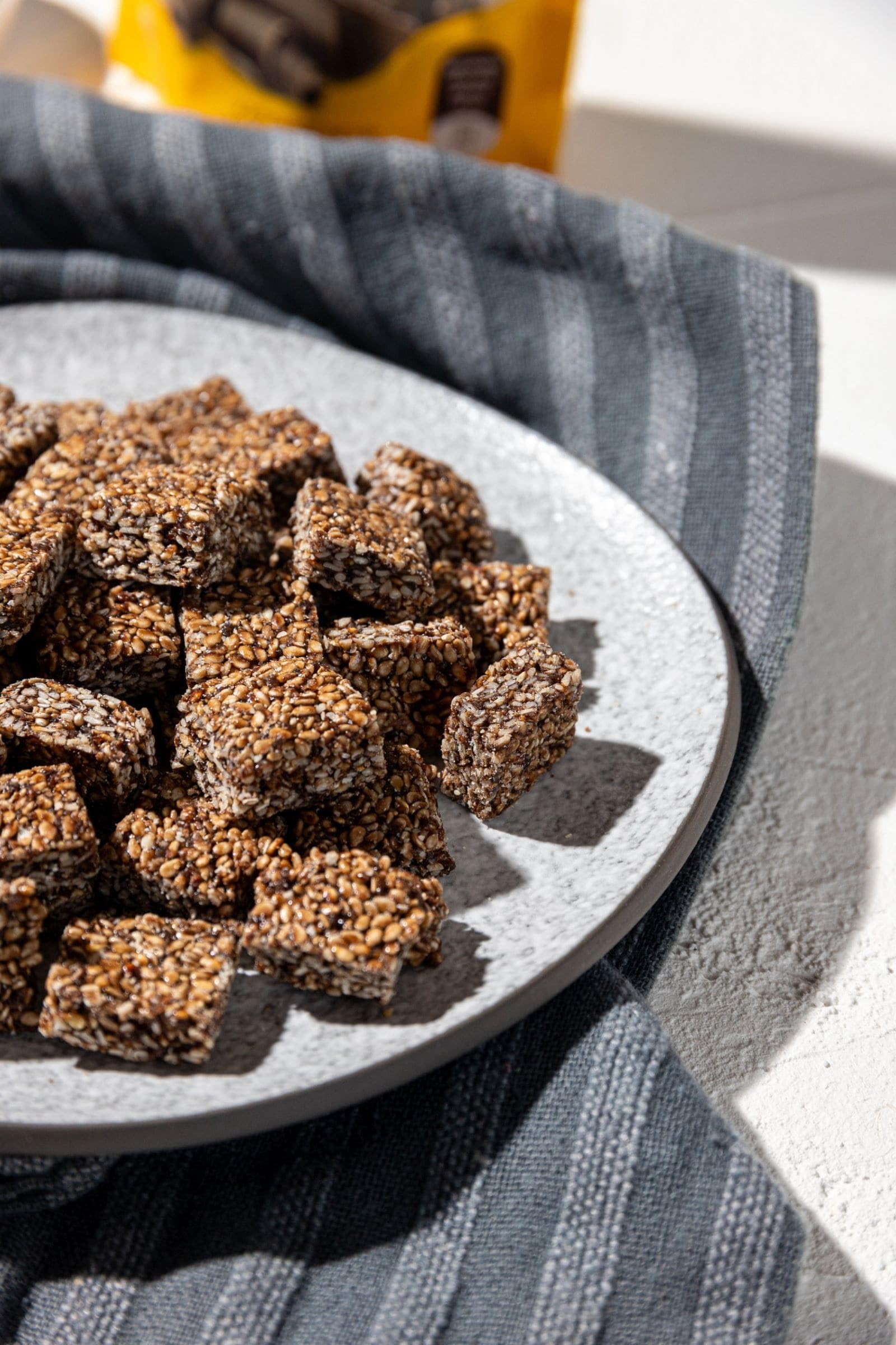 Close-up of dark chocolate-coated sesame bites with thyme honey aroma.