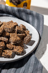 Close-up of dark chocolate-coated sesame bites with thyme honey aroma.