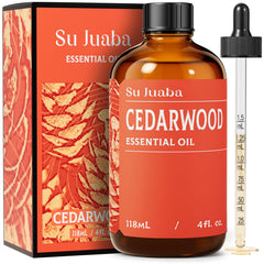SU JUABA Cedarwood oil amber bottle on wood, pure aromatherapy for relaxation.