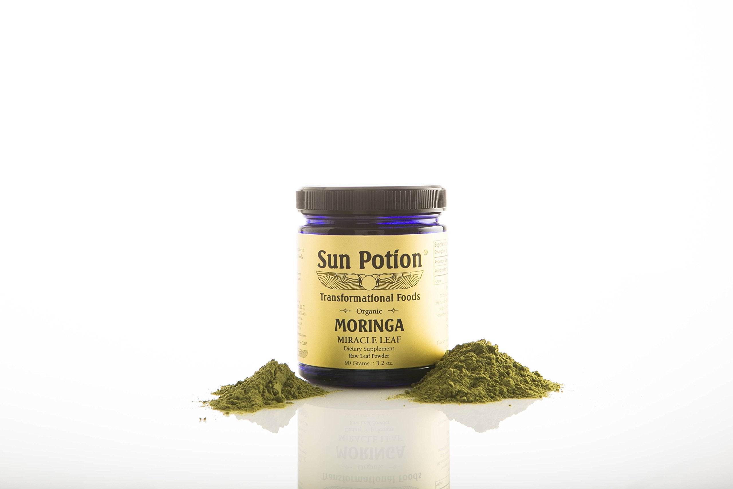 Sun Potion Moringa leaf powder in a glass with fruit and greens