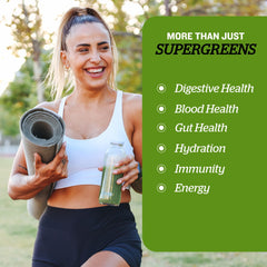 Sunfood Supergreens being stirred into water for a nutrient-rich drink.