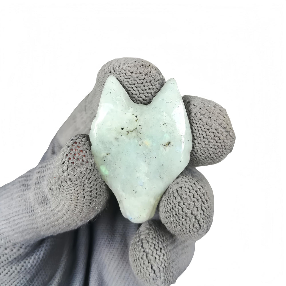 Sunshcat Moonstone Wolf Head Figurine held in hand reveals compact size and craftsmanship.