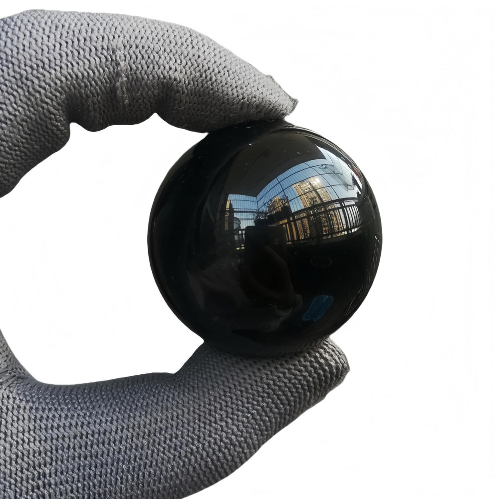 Sunshcat obsidian sphere closeup showing natural patterns for meditation