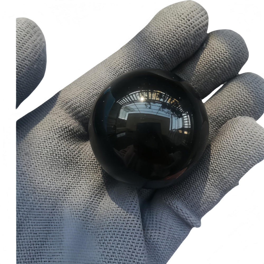 Sunshcat obsidian sphere used as desk decor in a calm workspace