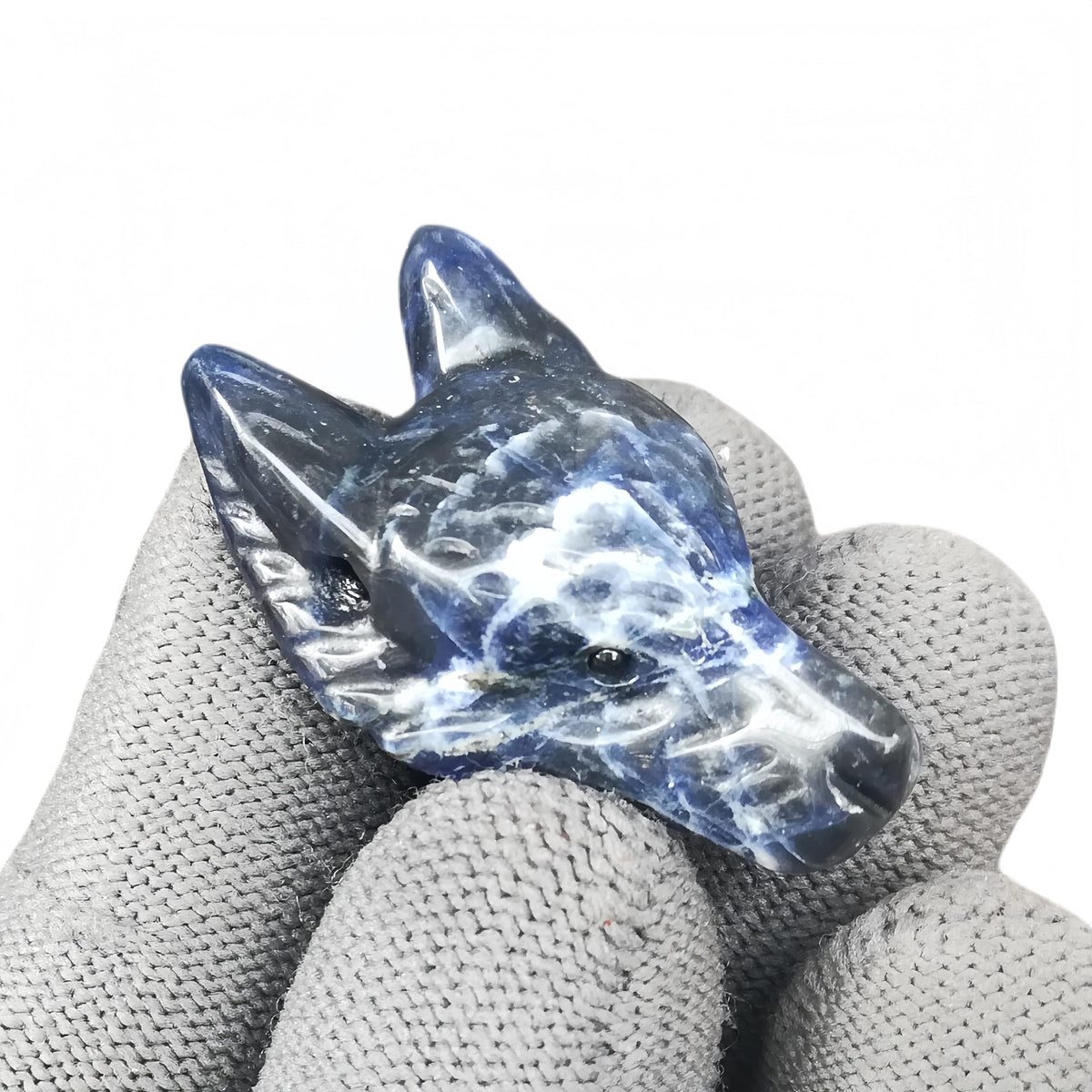 Sunshcat sodalite wolf head figurine, a pocket crystal promoting calm energy and focus.