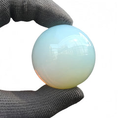 Sunshcat Opalite ball in serene desk setup for Feng Shui energy.