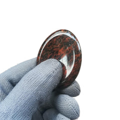 Sunshcat thumb stone held in hand demonstrates a simple relaxation technique.