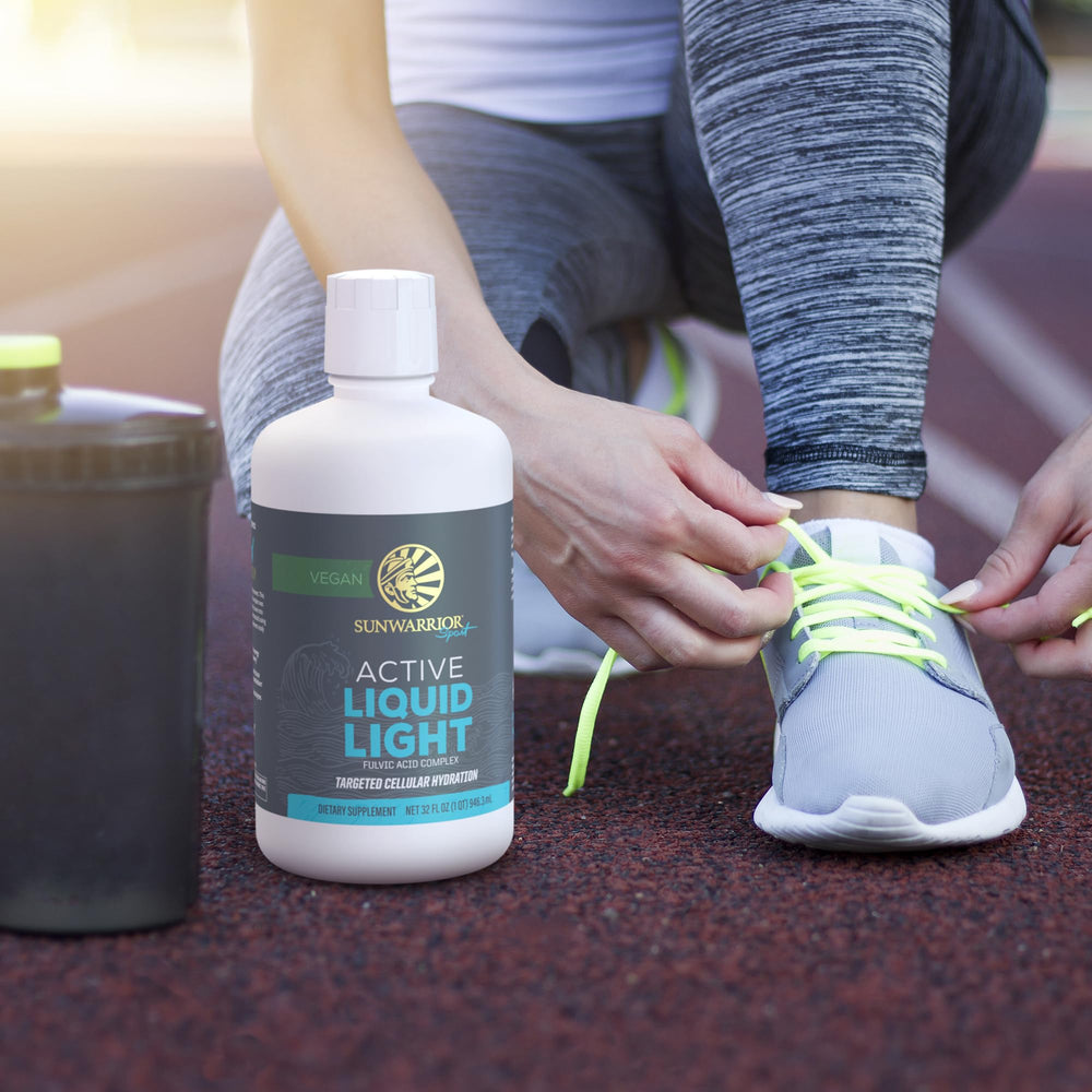 Sunwarrior Fulvic Acid Drops beside citrus fruits.