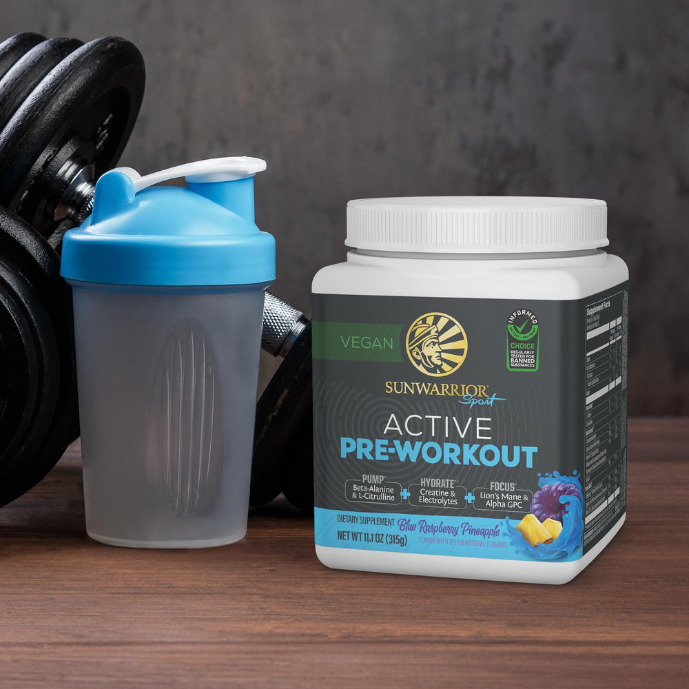 Sunwarrior Pre-Workout tub with spoon ready for your next training session.